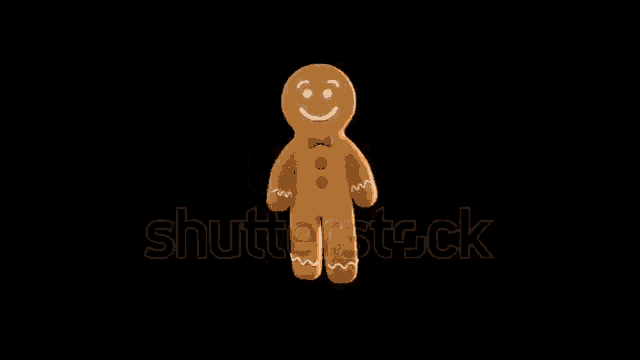 a gingerbread man with a bow tie is standing on a black background .