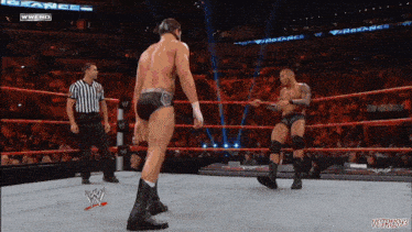 two men in a wrestling ring with the words vengeance on the bottom right