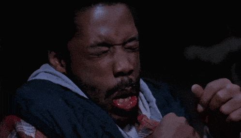 a man with a beard has his mouth open and his hands outstretched