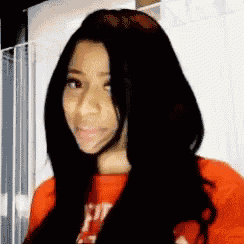 a woman with long black hair is wearing a red shirt that says ' a ' on it .