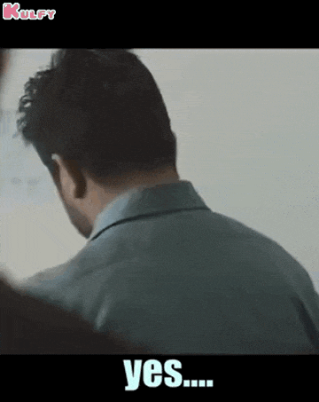 a man in a suit is standing in front of a white board and says yes ...