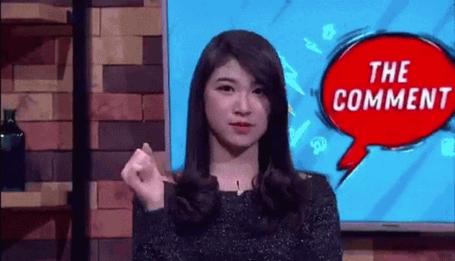 a woman is standing in front of a television with a speech bubble that says the comment .