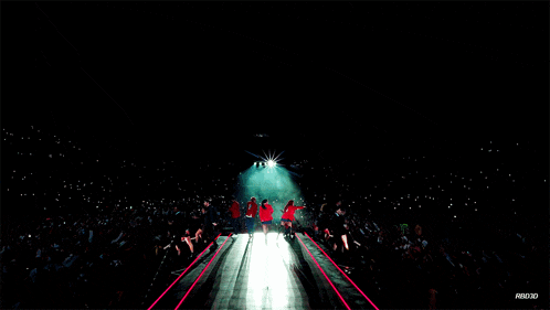 a group of people standing on a stage in front of a crowd with the word ab00x on the bottom left