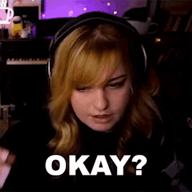 a woman wearing headphones is making a funny face and asking okay .