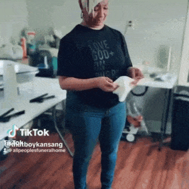 a woman is wearing a black shirt that says love god on it