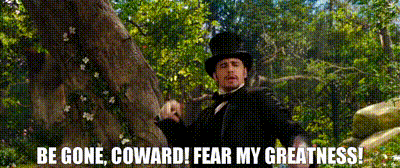 a man in a top hat is standing in front of a tree with the words be gone coward fear my greatness .