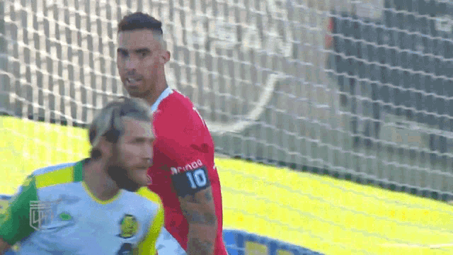 a soccer player with the number 10 on his armband