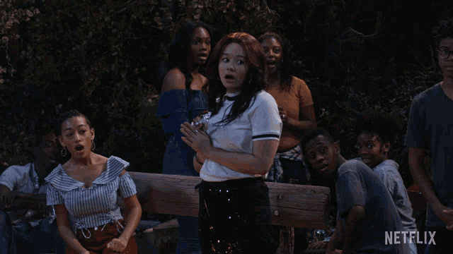 a group of people are gathered around a wooden bench with a netflix logo in the corner