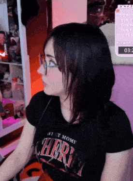 a woman wearing glasses and a shirt that says west mome cheri