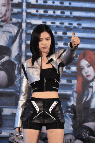 a woman giving a thumbs up in front of other women