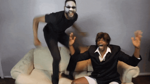 a man with a mask on his face is jumping in the air next to another man