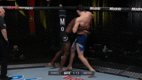 two men are wrestling in a ufc ring with 1:12 left