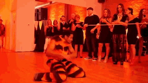 a man in a tiger costume is kneeling on the floor