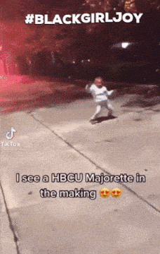 a little girl is dancing on a sidewalk with a caption that says blackgirljoy