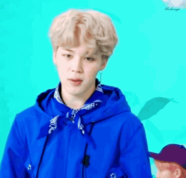 a man wearing a blue jacket and a bandana around his neck