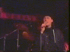 a close up of a person holding a microphone in front of their face