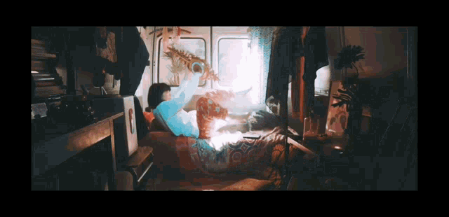 a person laying on a bed with a saxophone in their hand