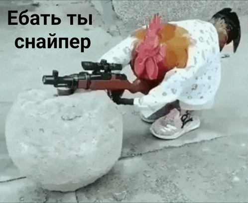a child is kneeling down holding a gun next to a chicken and a snowball with russian writing on it