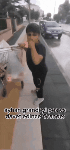 a person standing on a sidewalk with a shopping cart and the words ayhan grandeyi pes vs davet edince grande