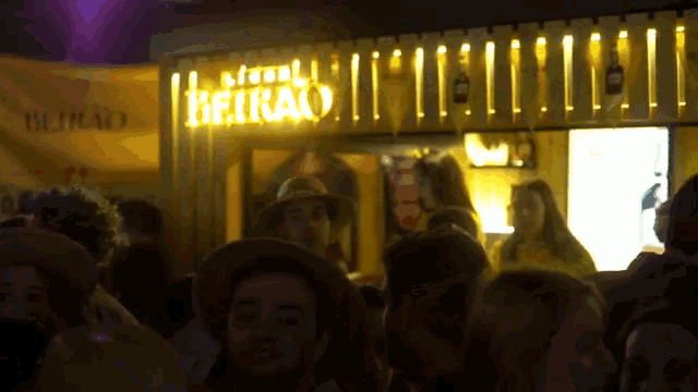 a crowd of people are gathered in front of a sign that says rio de janeiro on it