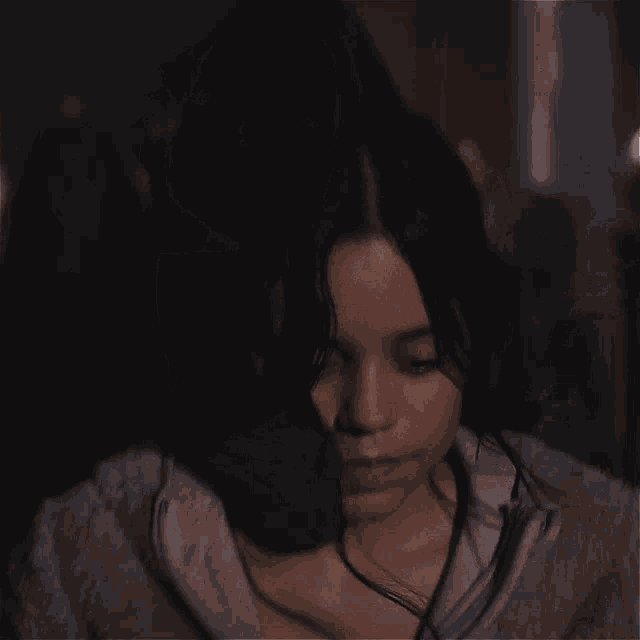 two women are standing next to each other and one has a necklace on her neck