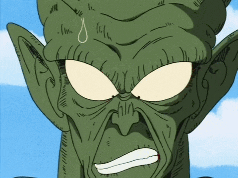 a close up of a green cartoon character 's face with a blue sky in the background