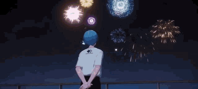 a boy with blue hair is watching fireworks in the night sky while wearing a white shirt that says ' sonic ' on it
