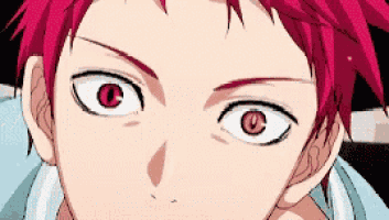a close up of a person 's face with red hair and big eyes .
