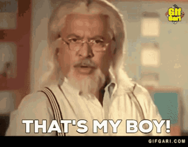 a man with long blonde hair and a beard is saying that 's my boy .