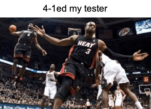 a basketball player wearing a heat jersey is jumping in the air while playing basketball