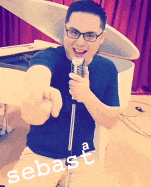 a man singing into a microphone with the name sebast written on the bottom