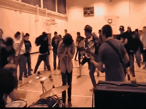 a group of people are gathered in a gym with the number 5 on the back of a shirt