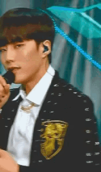 a close up of a man holding a microphone in his mouth