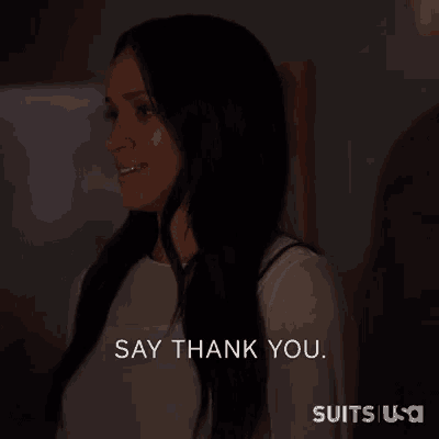 a woman says " say thank you " in a dark room