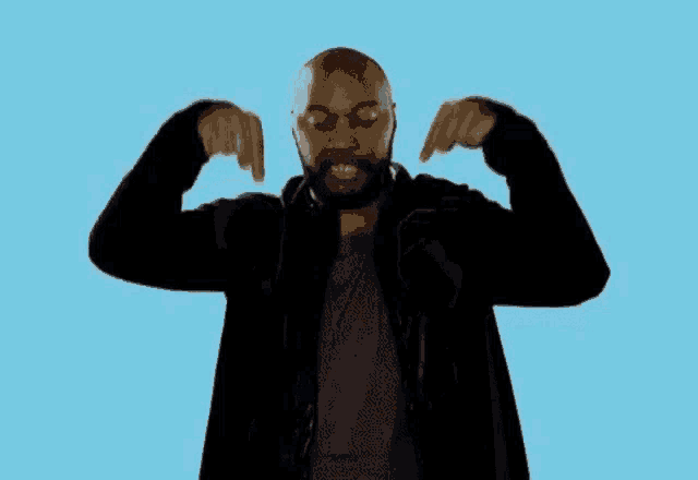 a bald man with a beard is pointing at himself with his fingers .