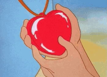 a cartoon character is holding a red heart shaped object