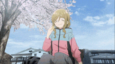 a girl in a pink and blue jacket sits under a tree with cherry blossoms