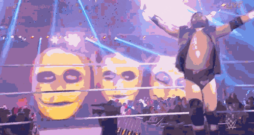 a man in a wrestling ring with a w logo on the bottom right