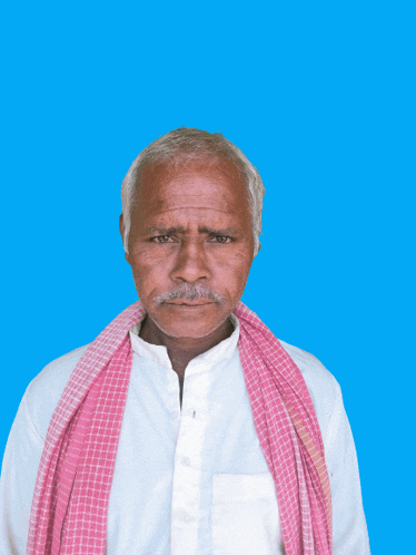 a man in a white shirt and a pink scarf around his neck
