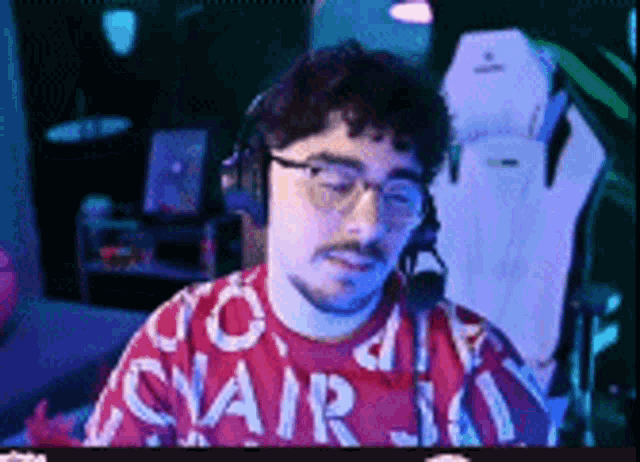 a man wearing headphones and a red shirt with the word stair on it .