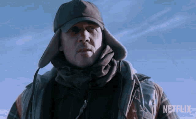 a man wearing a hat and scarf with a netflix logo in the corner