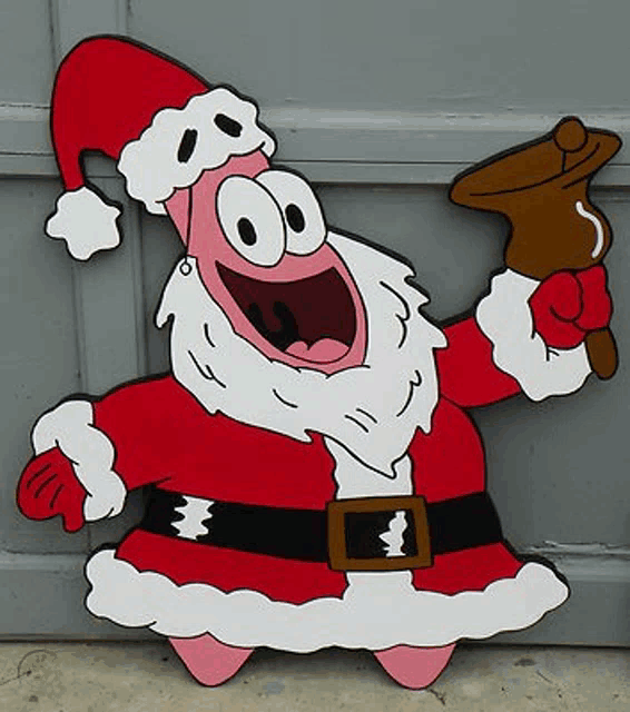 patrick star is dressed as santa claus and holding a bell