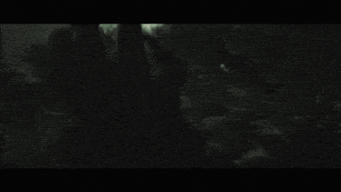 a black and white photo of a person riding a bike in the dark