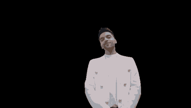 a man in a white jacket is standing in front of a black background with the word yes written on it