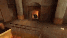 a fire is coming out of a hole in a wall in a room .