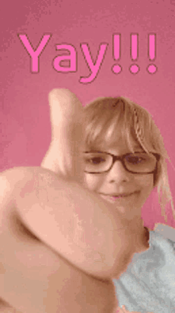 a girl wearing glasses is giving a thumbs up with the words yay !!! above her
