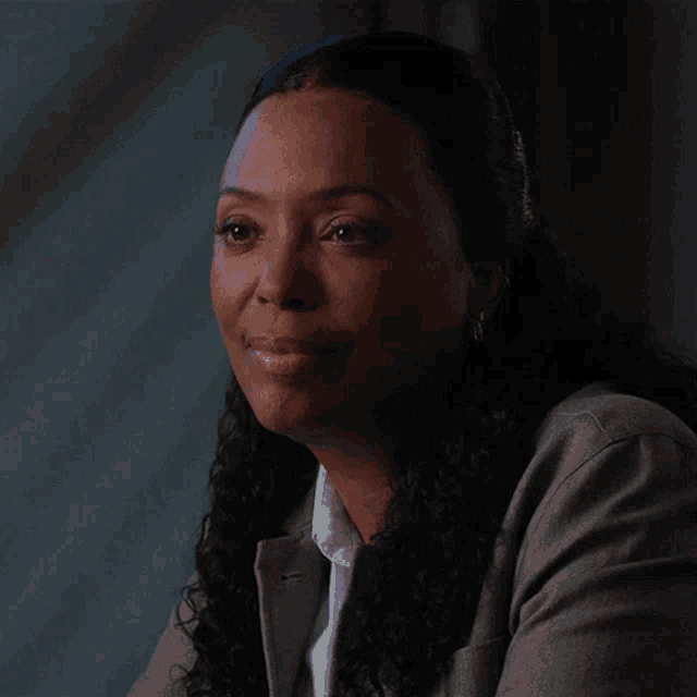a woman says yeah in front of a dark background