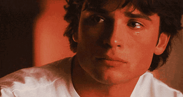 a close up of a man 's face with a tear running down his eye