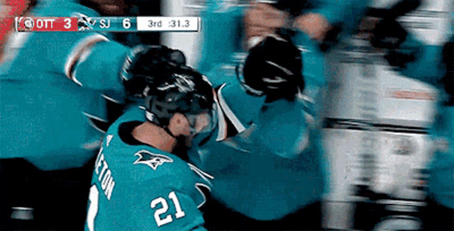 a hockey player with the number 21 on his jersey is fighting another player