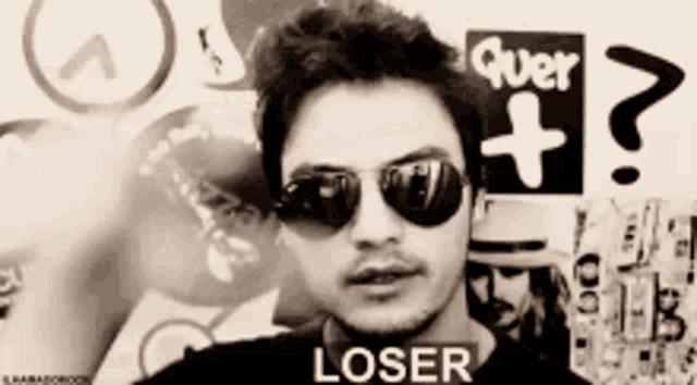 a man wearing sunglasses has the word loser written on his shirt